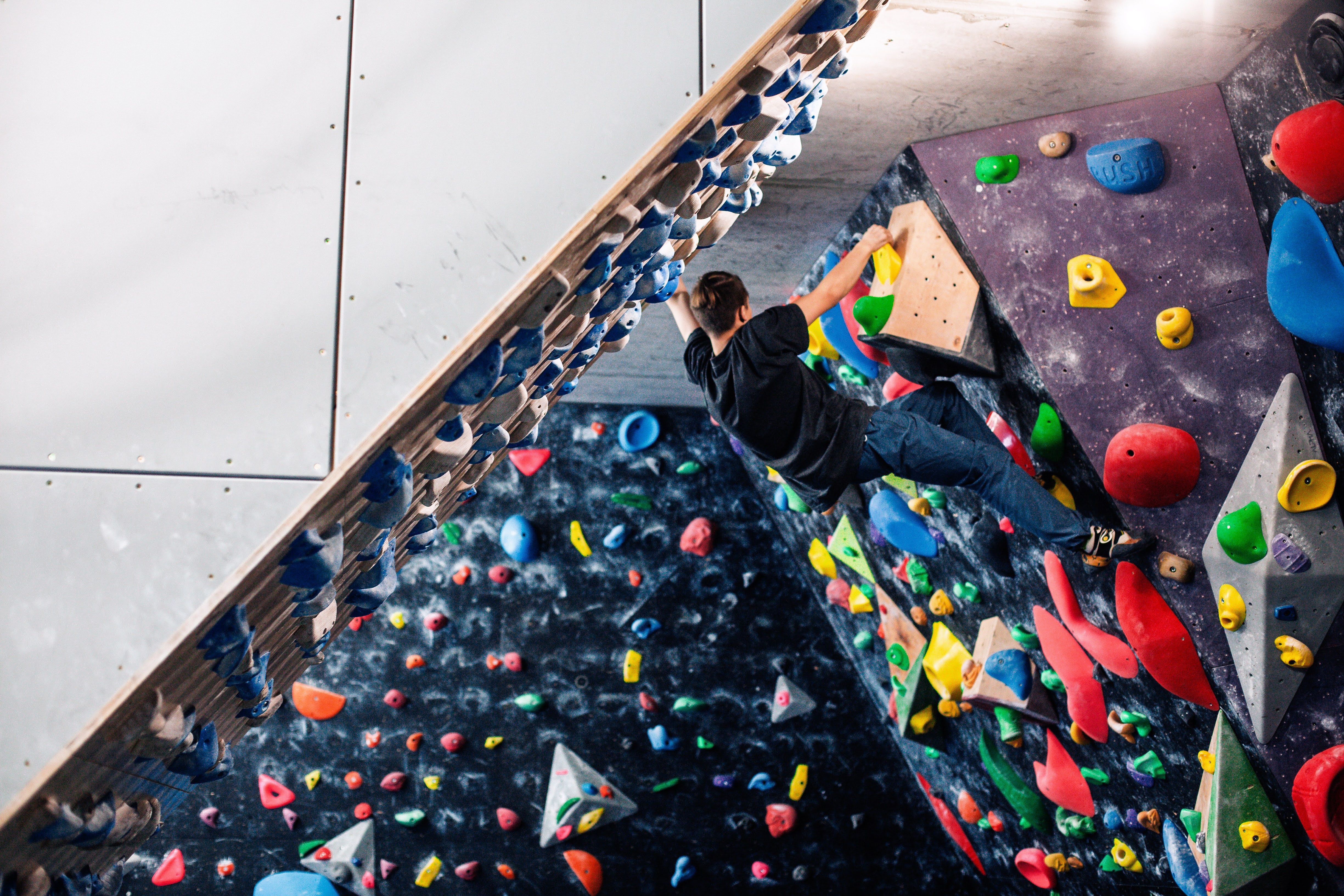 Climber training on diverse bouldering walls