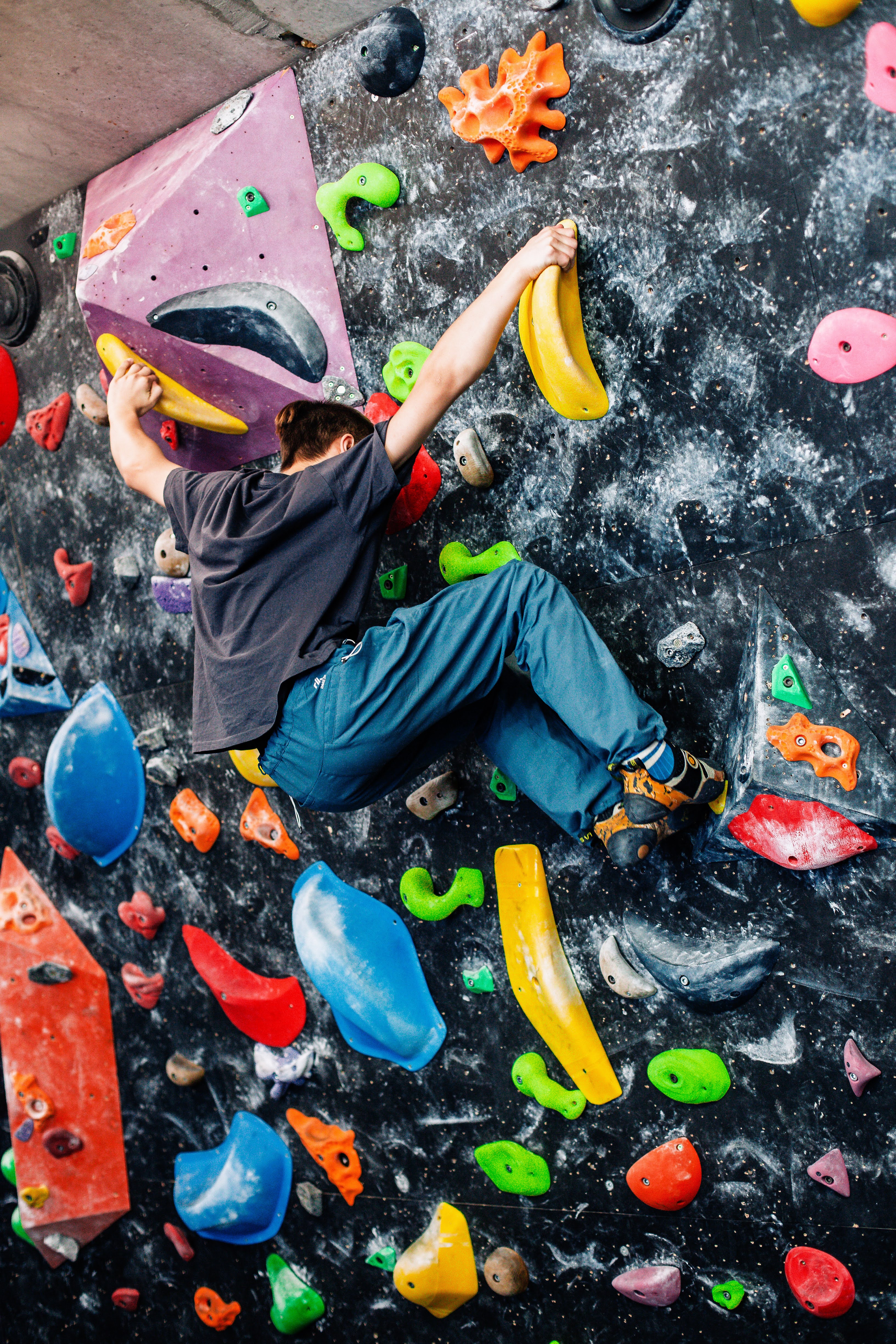 Child and adult climbing together on different wall sections