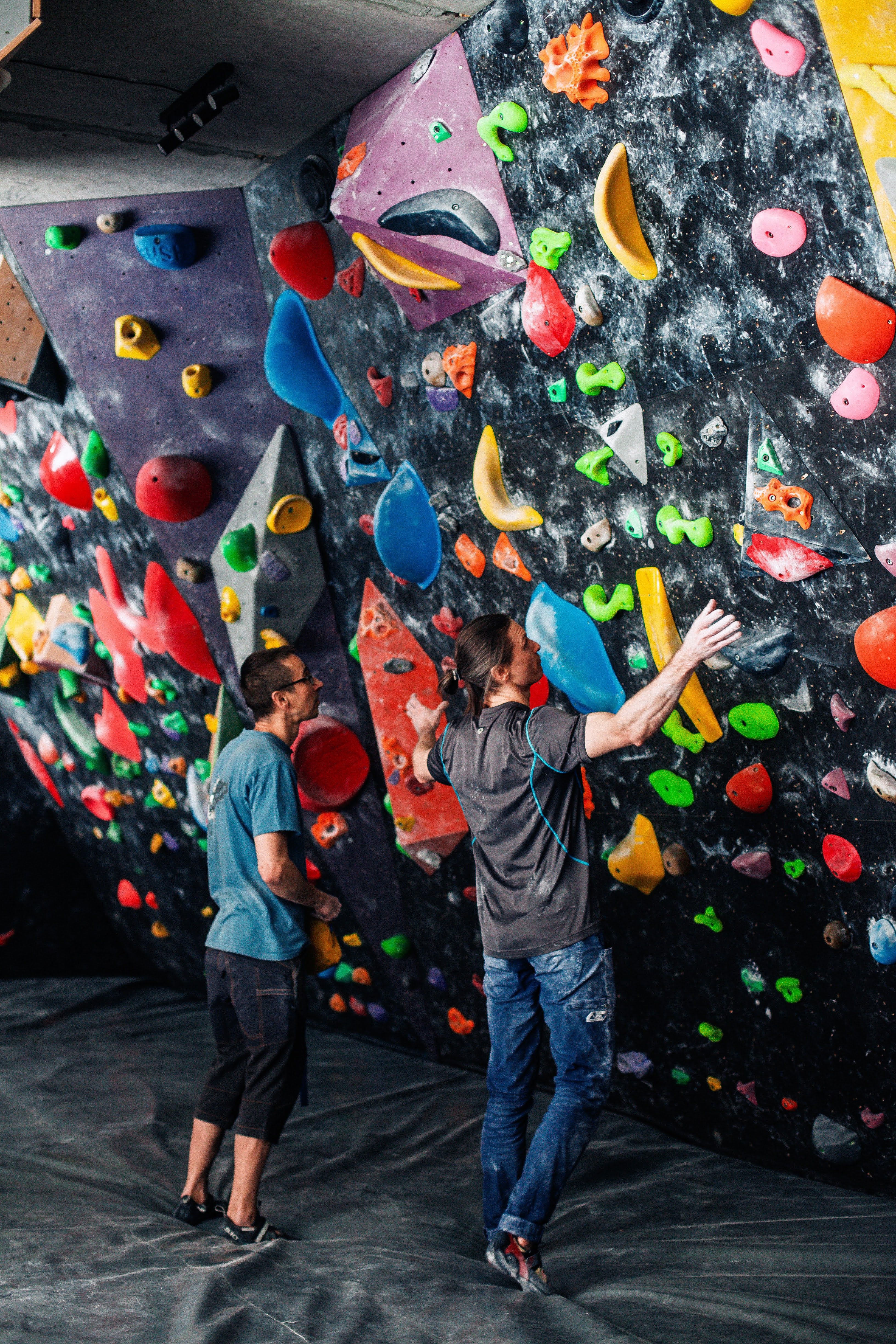 Two adults climbing together in group session